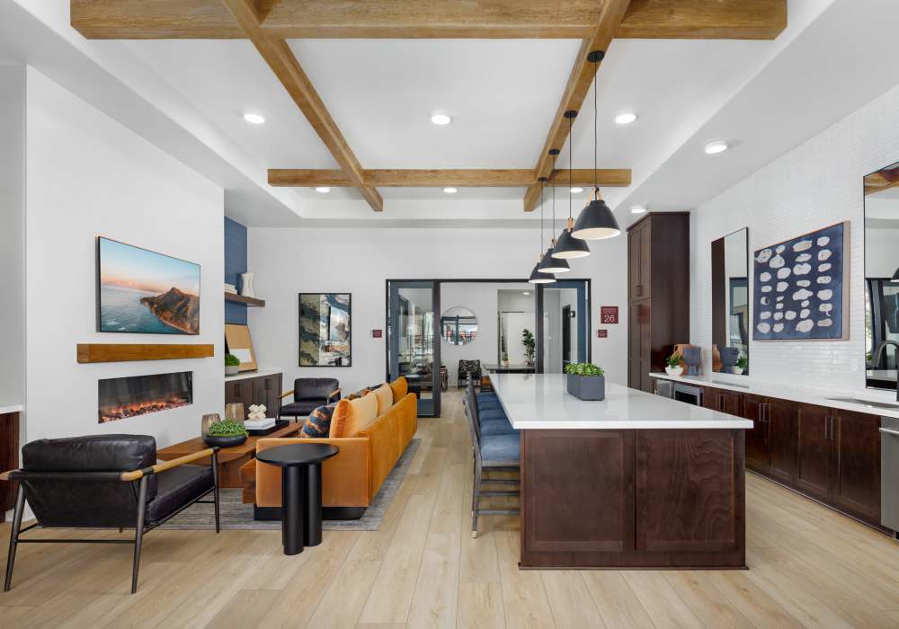 Resident lounge with TV and kitchen at Vida at Mountain House in Mountain House, California