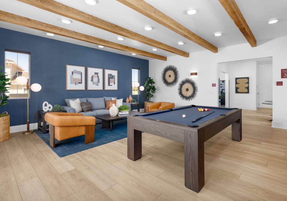 Game room with pool table and comfortable seating at Vida at Mountain House in Mountain House, California