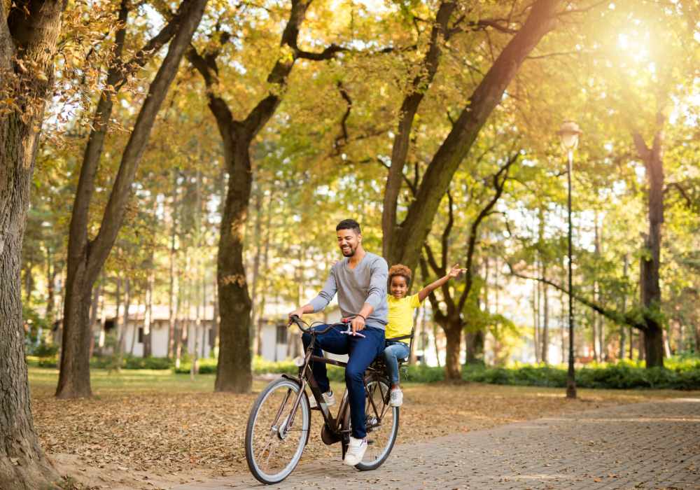 Father with his child riding bicycle near Bridges at San Ramon in San Ramon, California,