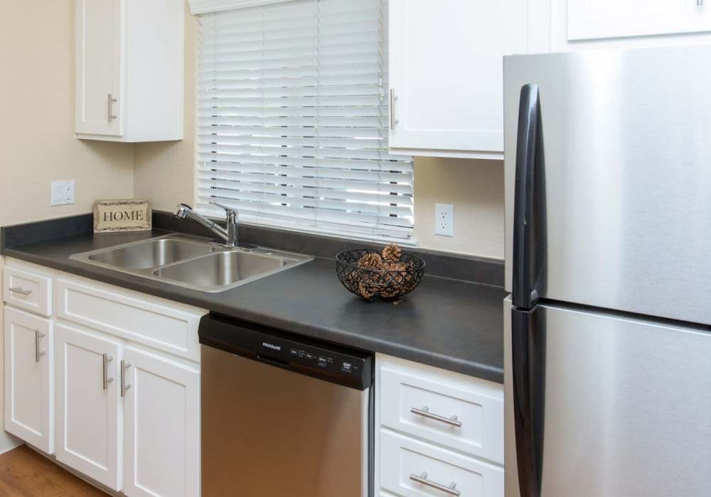Kitchen with white cabinet and window at Amber Court in Fremont, California