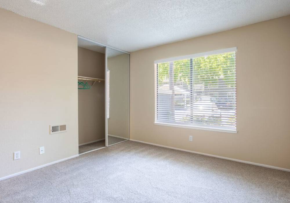 Unfurnished bedroom with closet, carpet flooring and window at Amber Court in Fremont, California