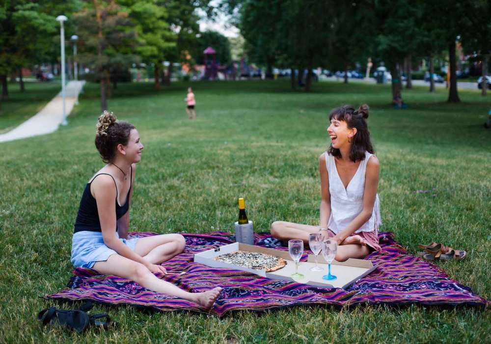 Two resident women relaxing in a park near Park Hacienda Apartments in Pleasanton,California