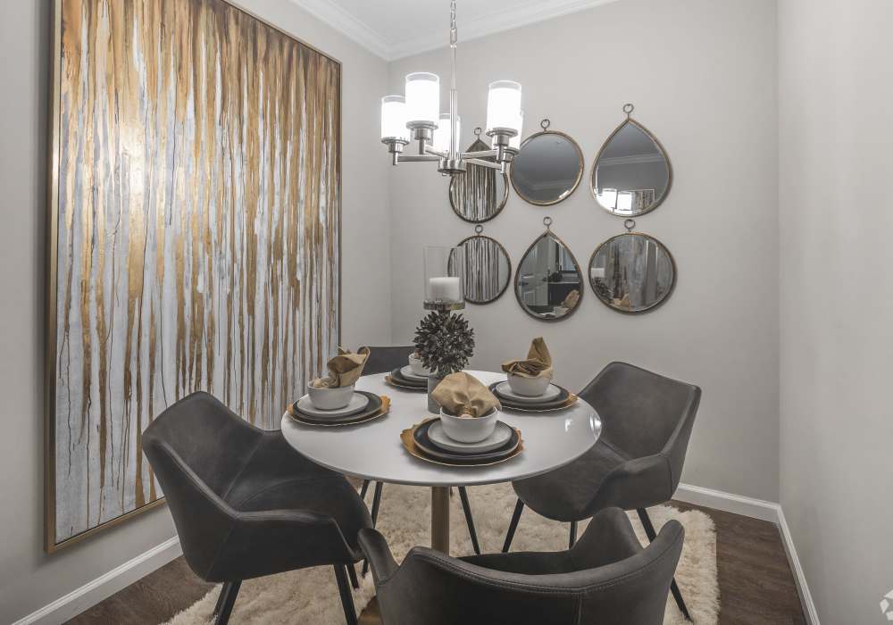 Fully-equipped kitchen with stainless steel appliances and island with bar chairs and pendant lights at Harborstone in Ladson, South Carolina