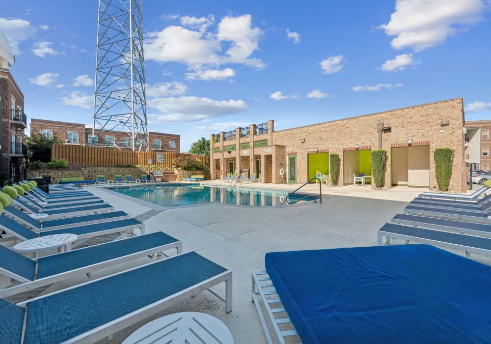 Sparkling pool with lounge seating at CityView Apartments in Greensboro, North Carolina