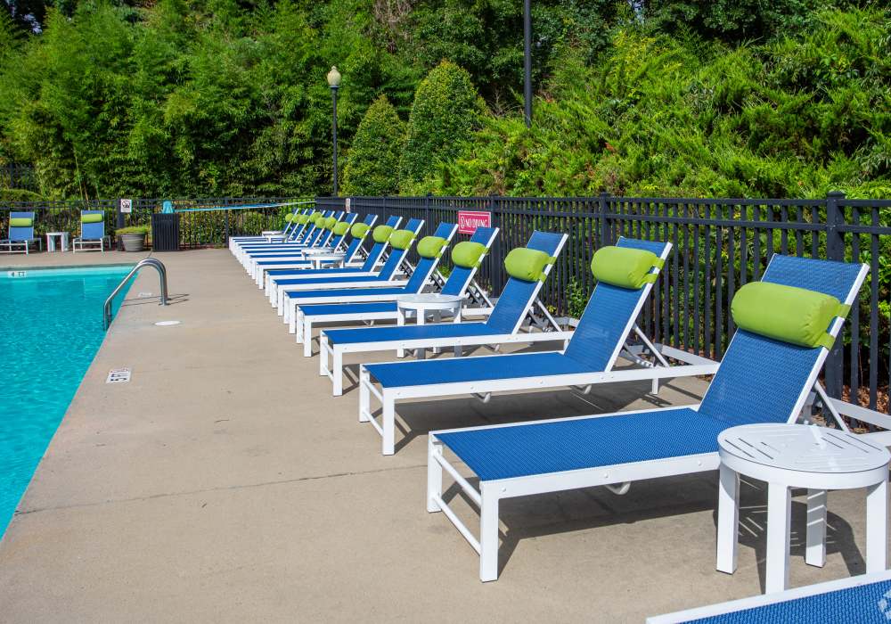 Resort-like sundeck and swimming pool with a lounge area and surrounding plants at Eagle Point Village in Fayetteville, North Carolina