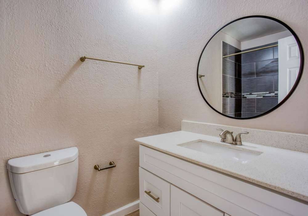 Bathroom with mirror at The Summit Apartments in Athens, Texas