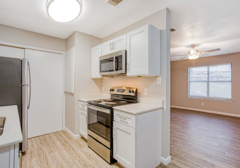 Kitchen with hardwood-style flooring at The Summit Apartments in Athens, Texas