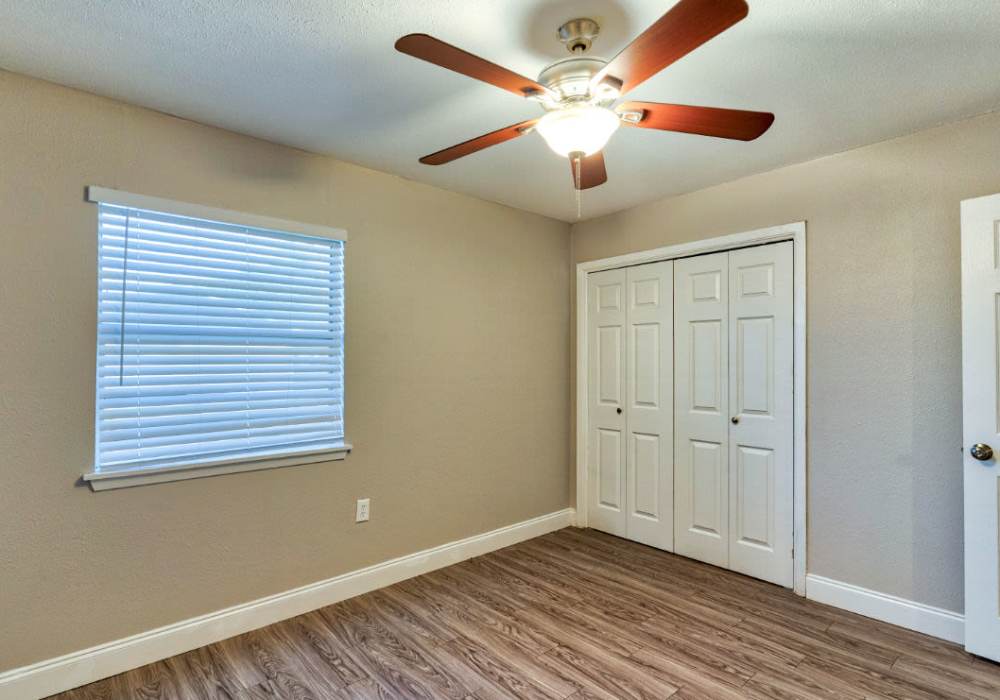 Bedroom with ceiling fan at Troup Townhomes in Troup, Texas