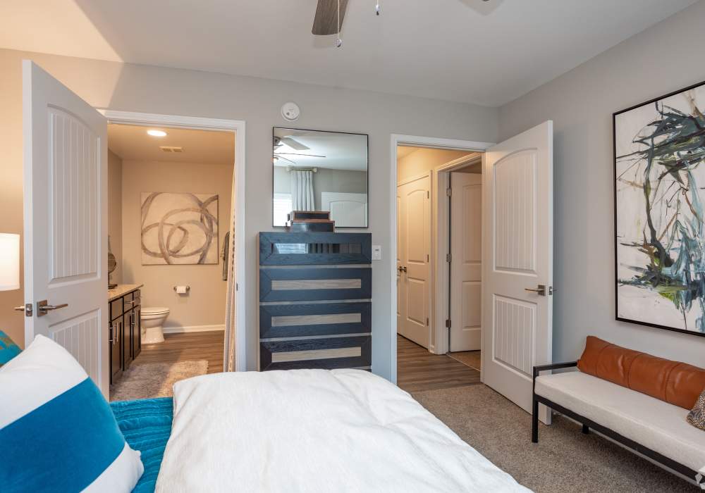Bright and spacious modern bedrooms with ceiling fan closet bathroom at Featherstone in Durham, North Carolina