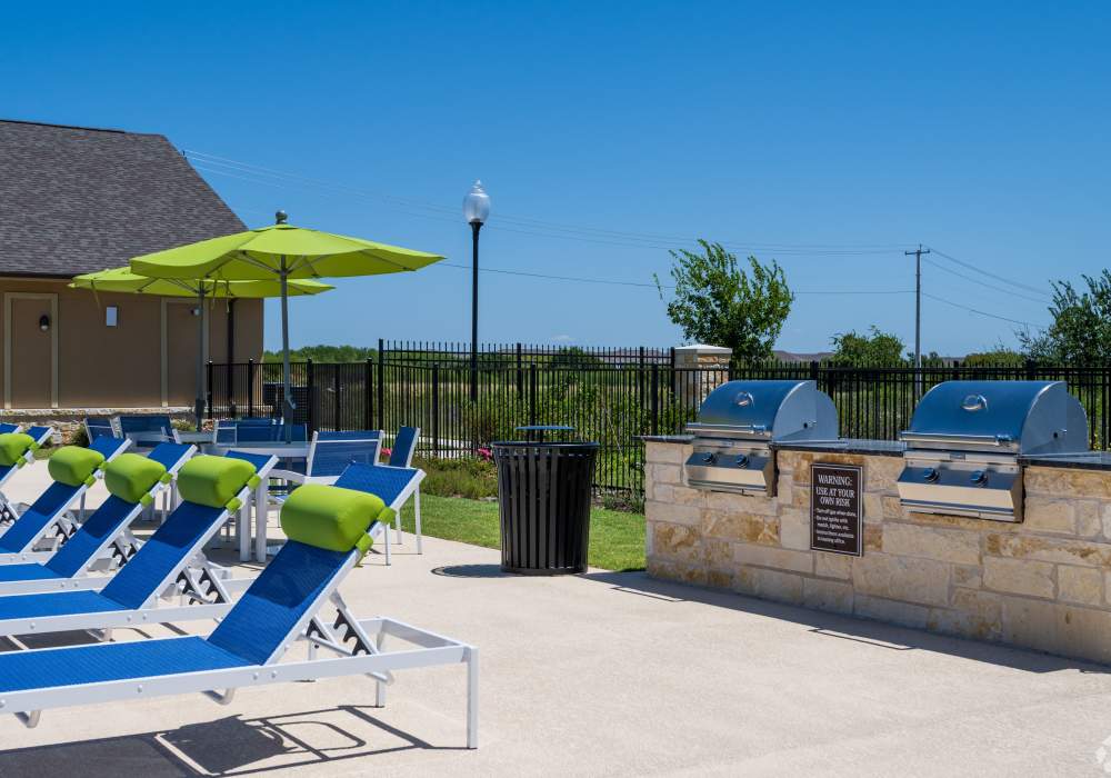 Grilling Station near Reclining Chairs at Poolside at Edenbrook Ridge in Pflugerville, Texas