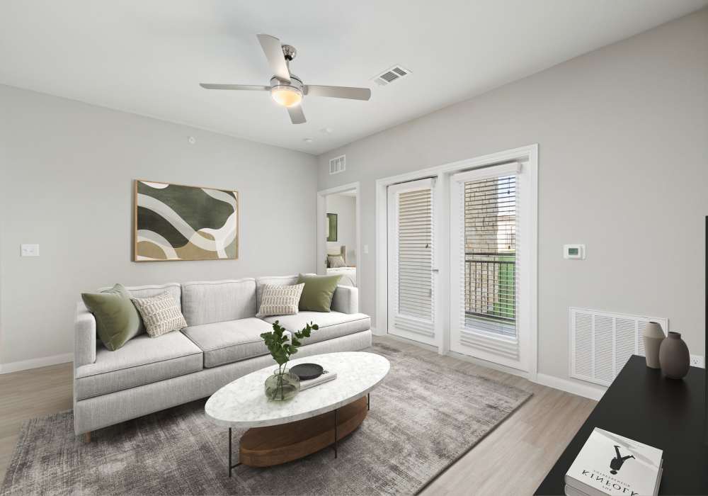 Living room with a ceiling fan and entrance at The Janson in Del Valle,Texas
