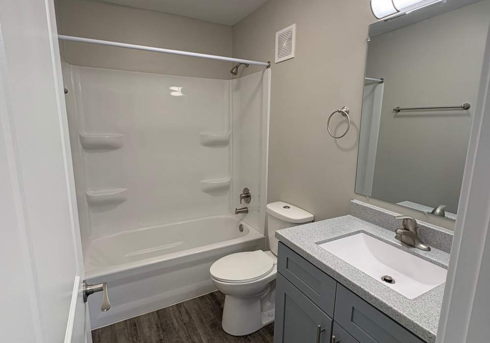 Bathroom with vanity mirror at Broadway Crossing Apartments in Merrillville, Indiana