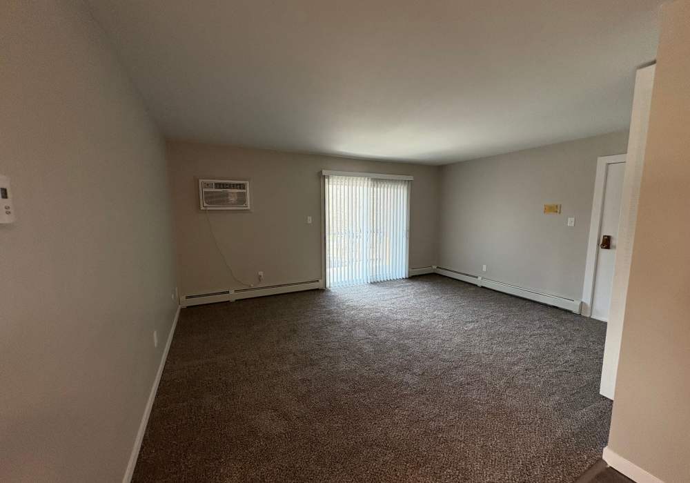 Living room with private patio at Broadway Crossing Apartments in Merrillville, Indiana