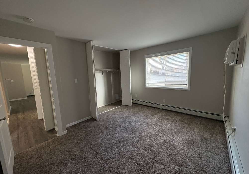 Bedroom with window at Broadway Crossing Apartments in Merrillville, Indiana