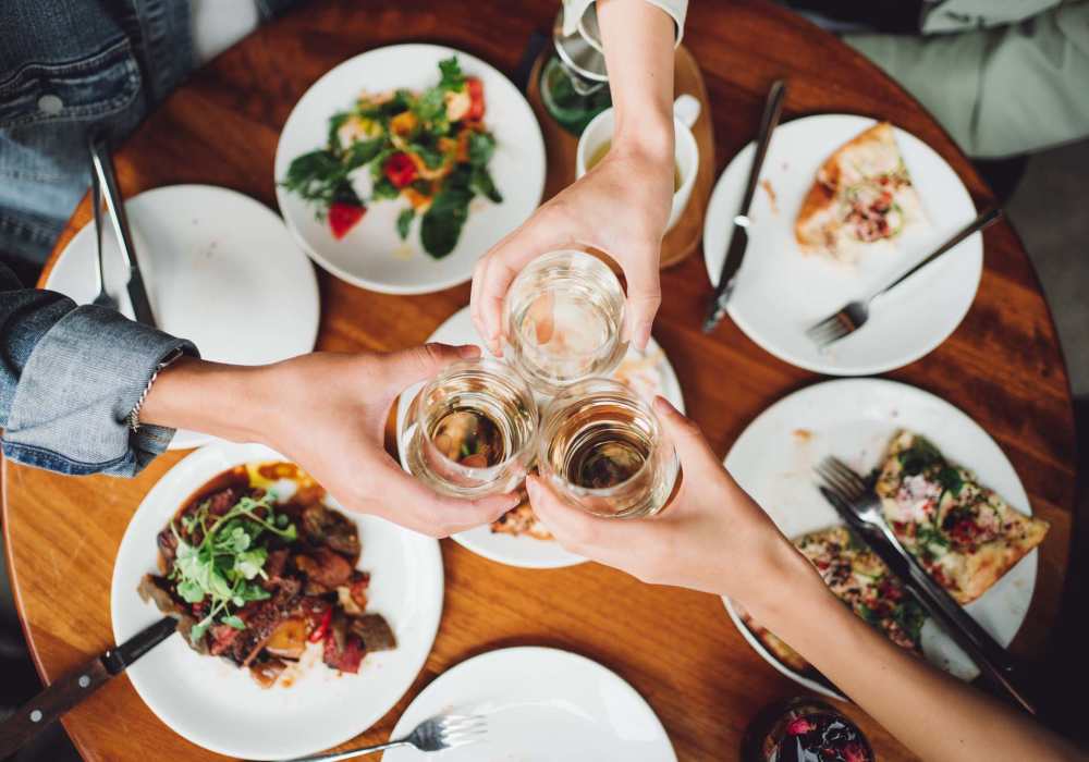 Residents having drinks and food at a restaurant near The Kensley in Spanish Fort,Alabama