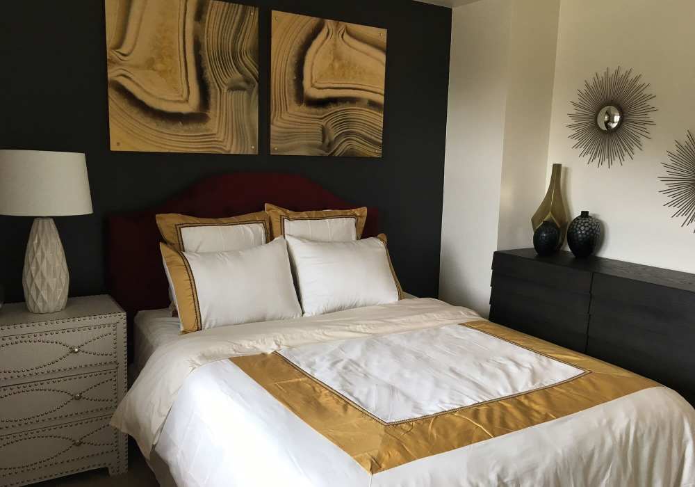 Model bedroom with wood-style flooring at Pacific Landing in Murrieta, California