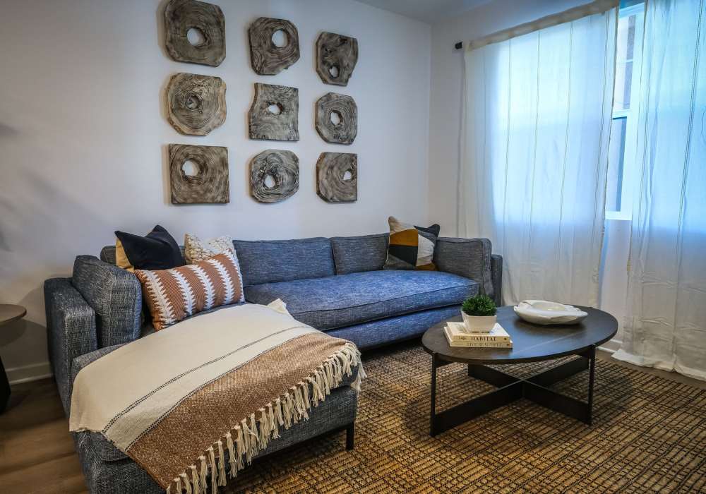 Stylish living room with large window at The Courtyards Pacific Village in San Diego, California