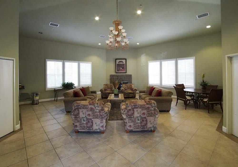 Spacious and inviting living area featuring cozy seating, natural light streaming through elegant windows, and tastefully designed decor perfect for relaxation and gatherings at River Run Village in San Diego, California