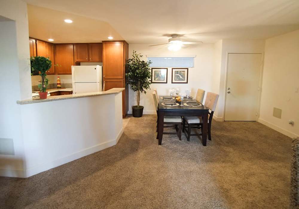 Bright and inviting dining area seamlessly blending with a modern kitchen at River Run Village in San Diego, California