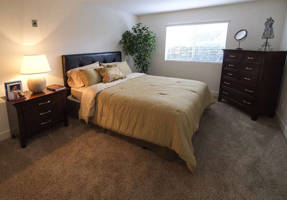 Cozy bedroom featuring plush carpeting at River Run Village in San Diego, California