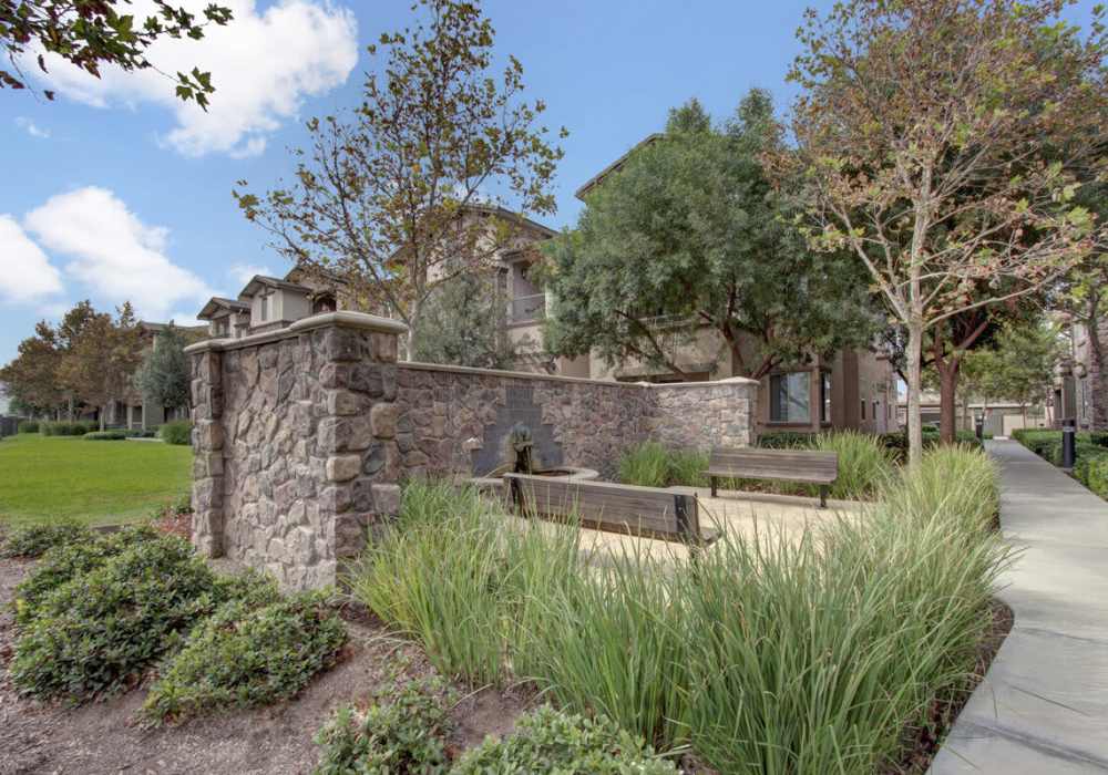 Green lawn with sitting area outside of leasing office at Rivers Edge in Lake Elsinore, California