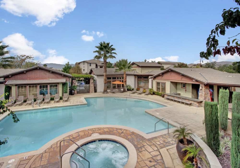 Swimming pool with sitting chairs and table at Rivers Edge in Lake Elsinore, California