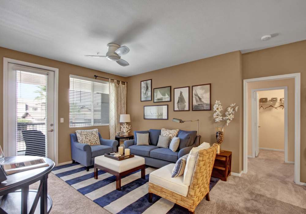 Spacious living room with couch, coffee table and access to patio through door with glass window at Rivers Edge in Lake Elsinore, California