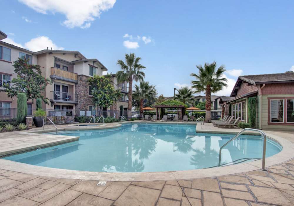Swimming pool with community building view at Rivers Edge in Lake Elsinore, California