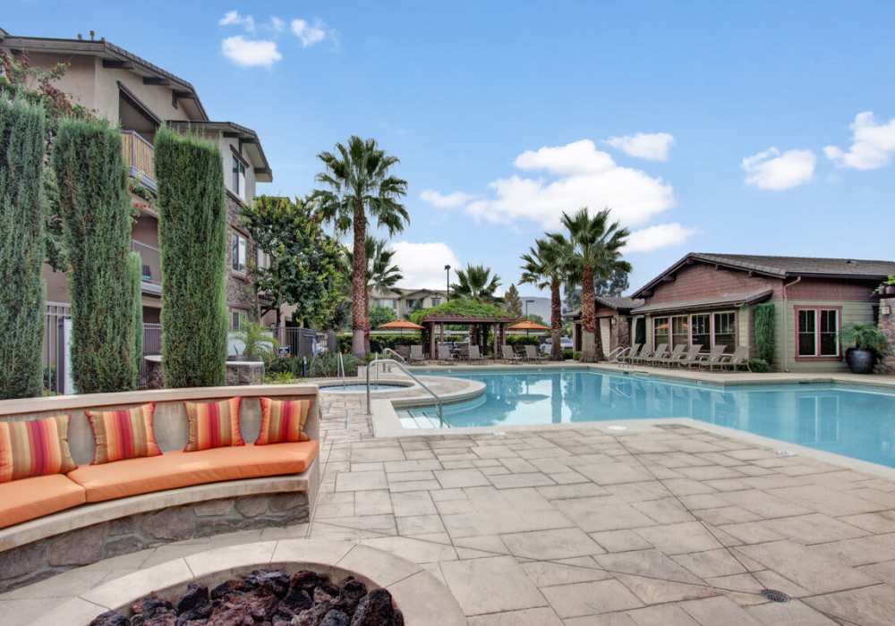 Outdoor seating area by the pool along with barbecue at Rivers Edge in Lake Elsinore, California