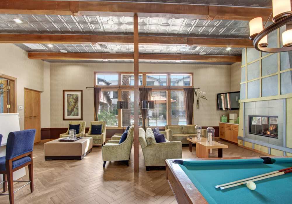Modern design clubhouse with couch and fireplace at  Rivers Edge in Lake Elsinore, California