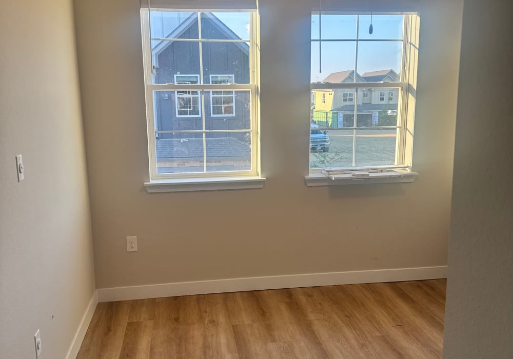 Windows in a home with wood-style flooring at Parkwood Oaks in Bedford, Texas