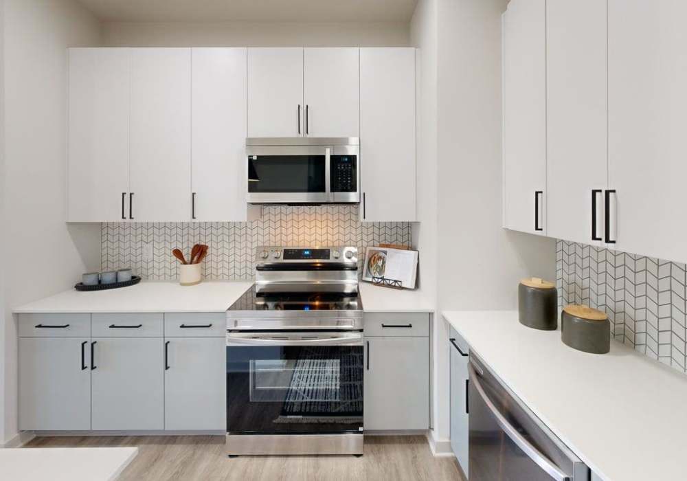 Women Slicing Fresh Zucchini on a Wooden Cutting Board at Silo Creek Apartments in Lafayette, Louisiana
