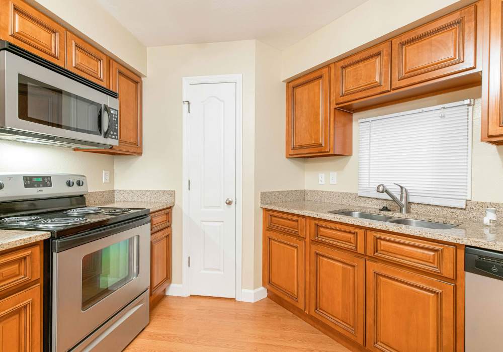 Kitchen with woden cabinets at Peachtree Apartments in Chesterfield, Missouri