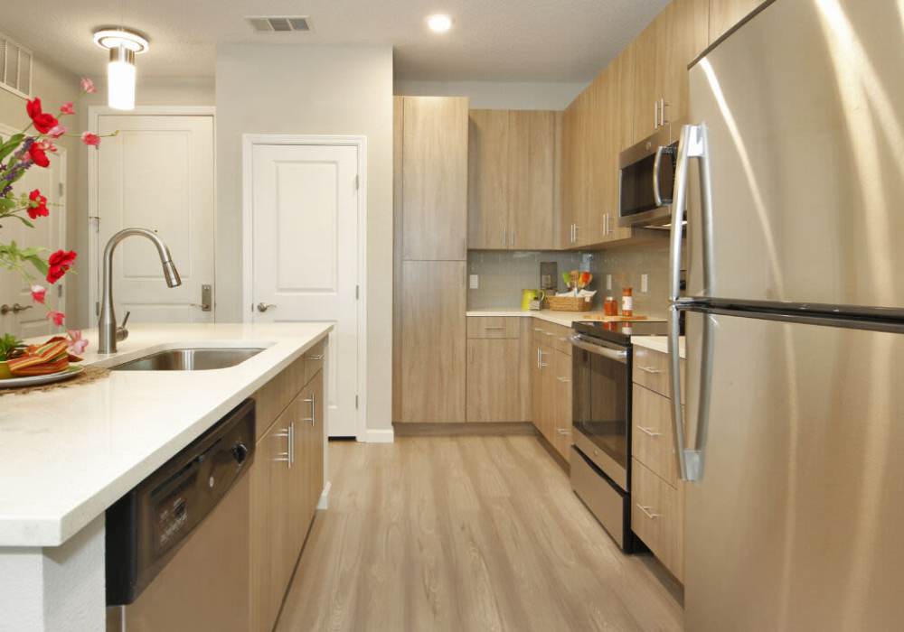 Upgraded kitchen with sleek appliances and modern finishes at Messina Luxury Apartments in New Smyrna Beach, Florida