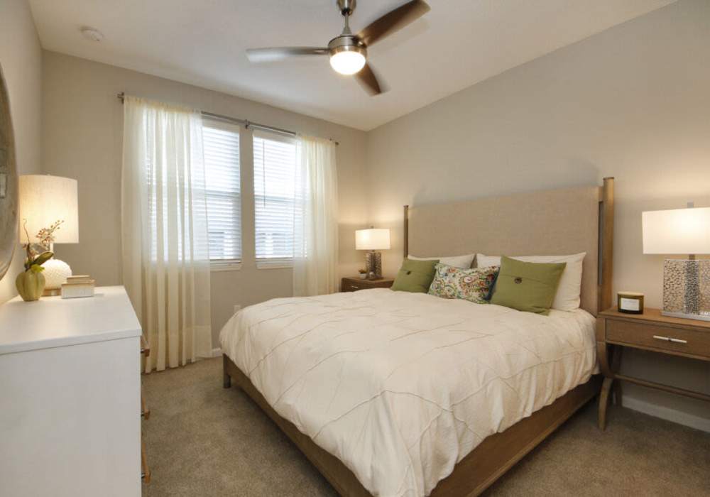 Cozy bedroom with soft lighting and elegant decor at Messina Luxury Apartments in New Smyrna Beach, Florida