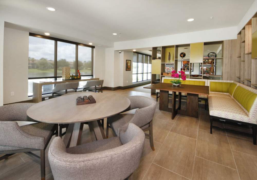 Modern dining area with bright windows and stylish seating at Messina Luxury Apartments in New Smyrna Beach, Florida