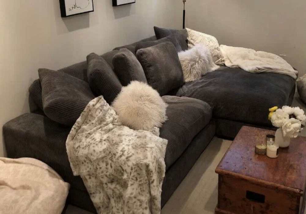 Cozy living room with plush pillows, and a wooden coffee table at Mount Vernon Arms Apartments in Merrillville, Indiana