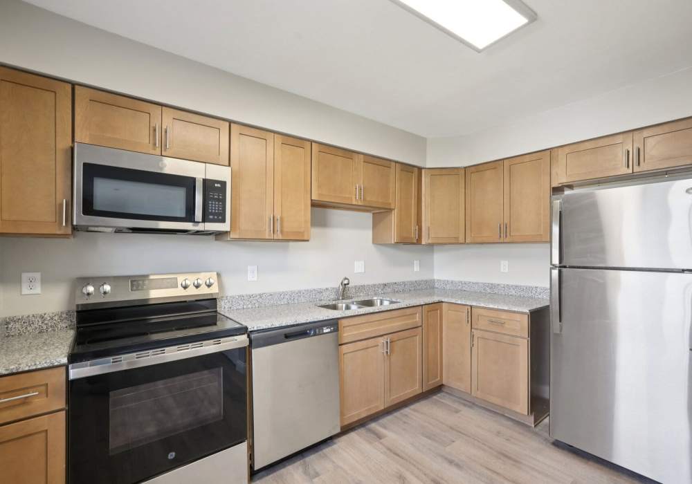 Kitchen with wooden flooring and cabinets at Charleston Square Apartments in Columbus, Indiana