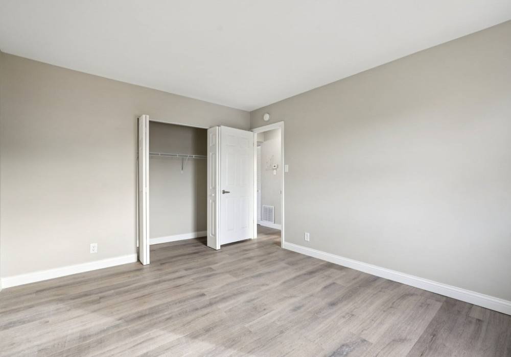 Unfurnished bedroom with wooden flooring and access to walking closet at Charleston Square Apartments in Columbus, Indiana