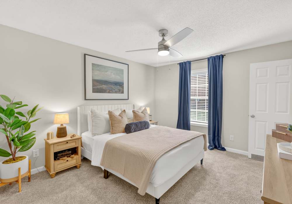 Cozy bedroom with bedside tables at Saddlebrook Apartments in Murfreesboro, Tennessee
