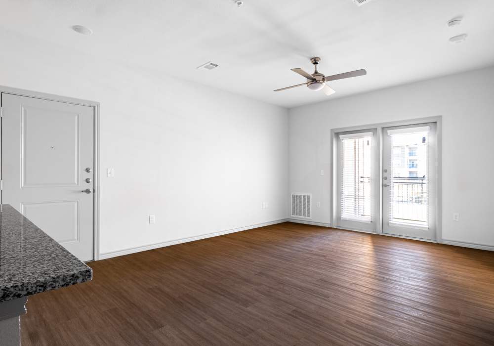 Living room with wood flooring and ceiling fan at Terrace at Southern Oaks in Dallas, Texas
