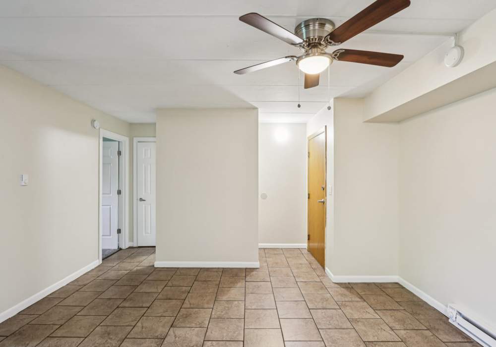 Spacious room with tiled floor and ceiling fan at Regents Park Apartments in Bensenville, Illinois