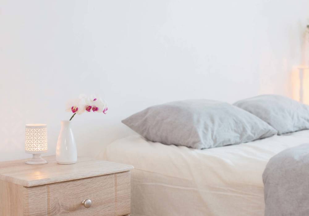 Cozy bedroom with soft pillows and decorative vase at Standard at Royal Lane in Dallas, Texas