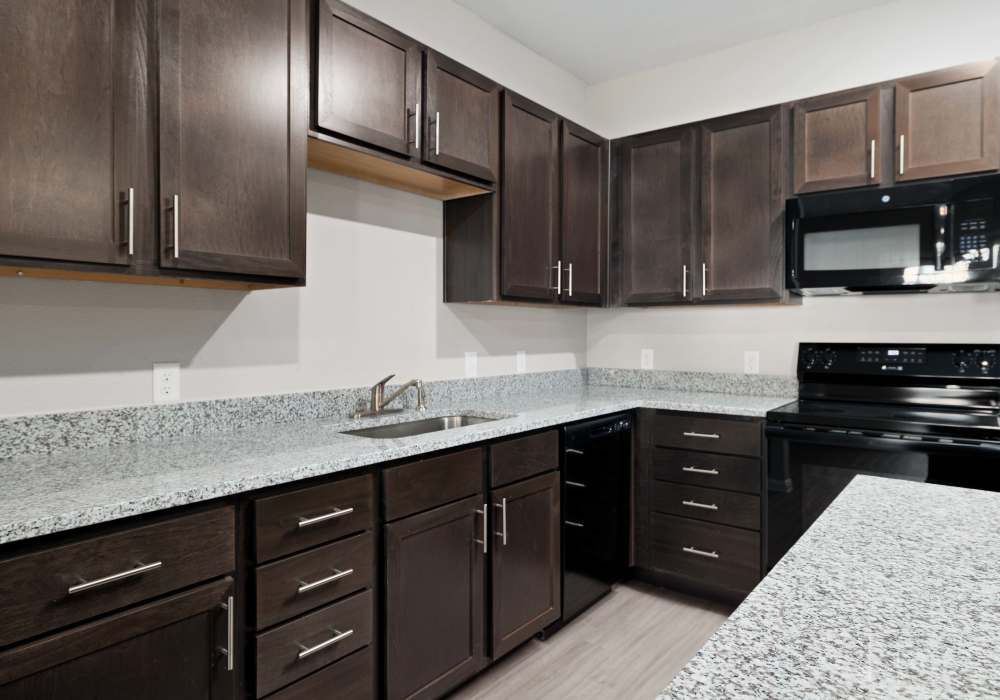 Kitchen with black colored appliances at Preserve at Gresham Lake in Raleigh,North Carolina