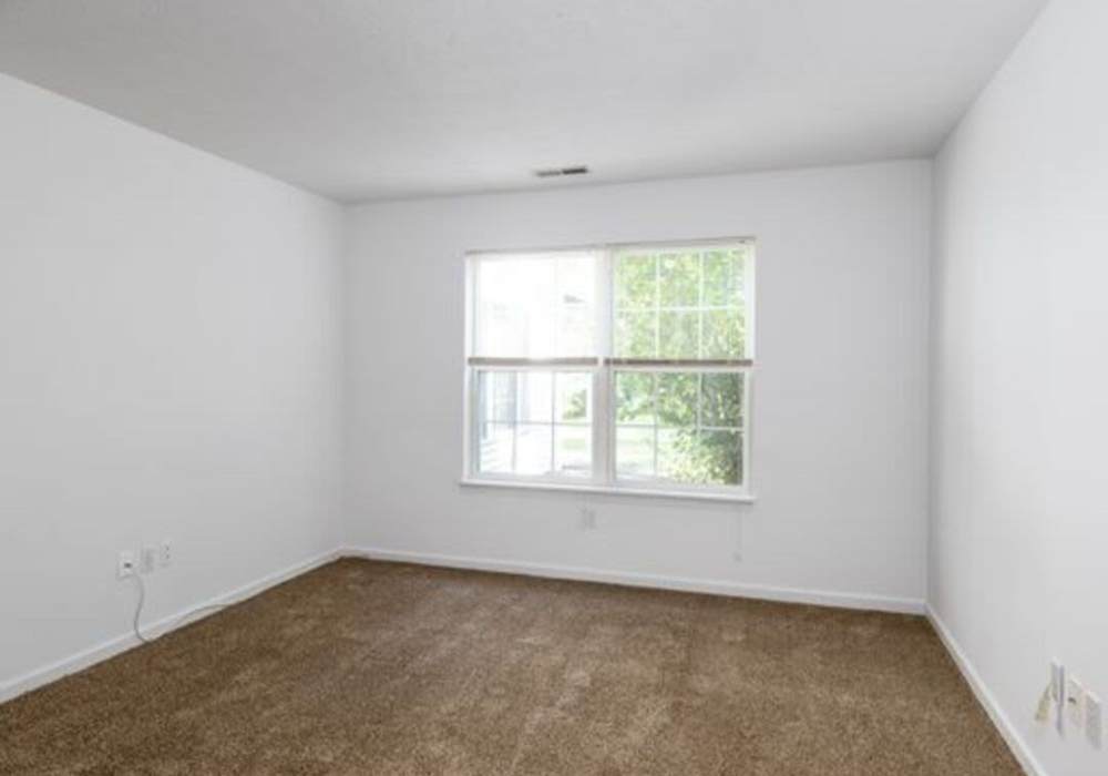 Bedroom with a window at Heritage Park Apartments & Townhomes in Webster, New York