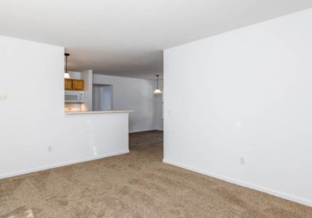 Living room with connecting kitchen at Heritage Park Apartments & Townhomes in Webster, New York