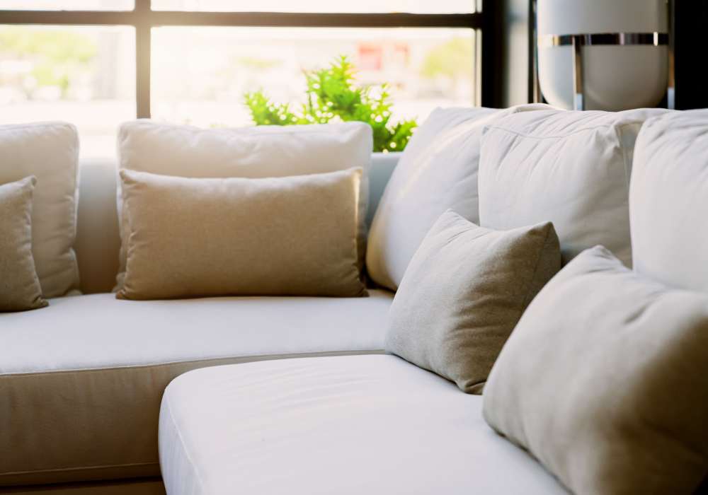 Cozy living room with plush cushions at Jefferson Manor Townhomes in Fairport, New York