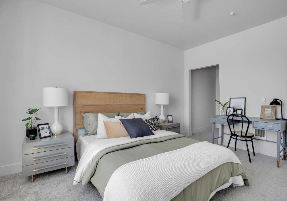 Bright bedroom with a cozy bed, stylish nightstands, and a desk for work or study at Tilian Point in Woodburn, Oregon
