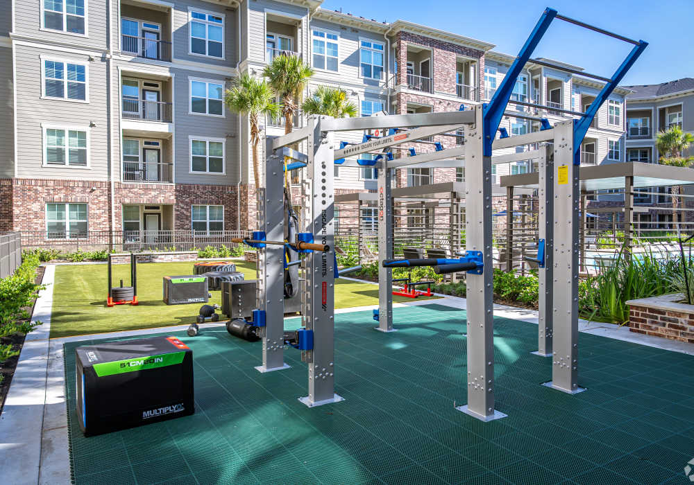 Outdoor fitness area featuring modern exercise equipment at Charleston at Fannin Station in Houston, Texas