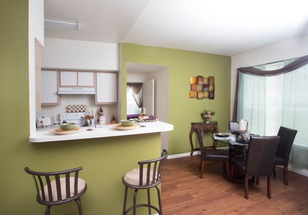 Kitchen with dining area and bar stools at Reata Apartments in Harlingen, Texas